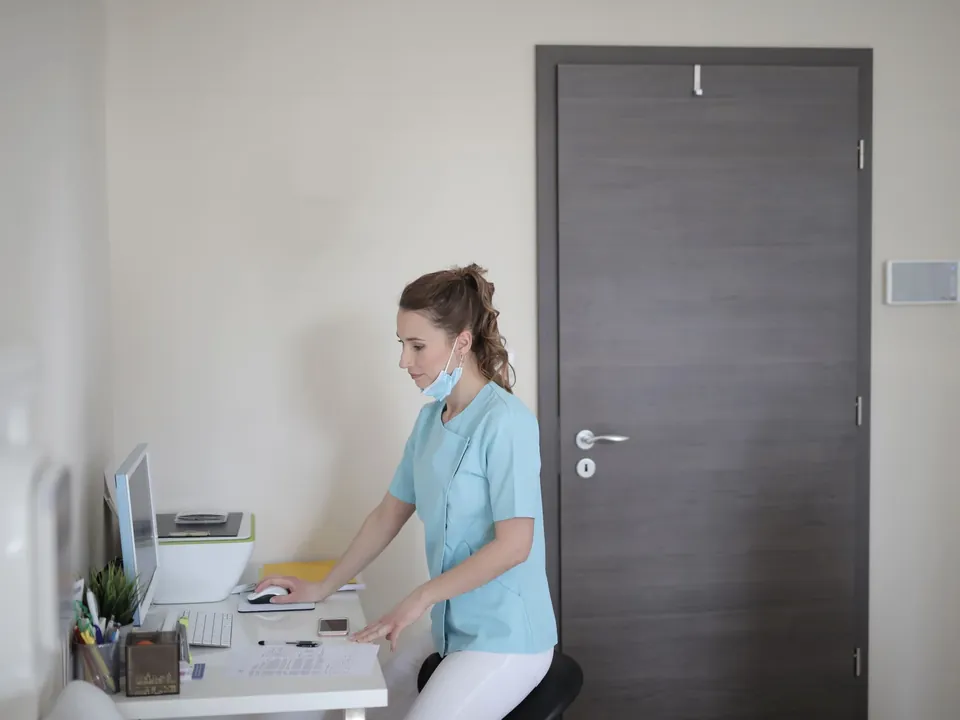 Healthcare professional using a workstation in a clinic