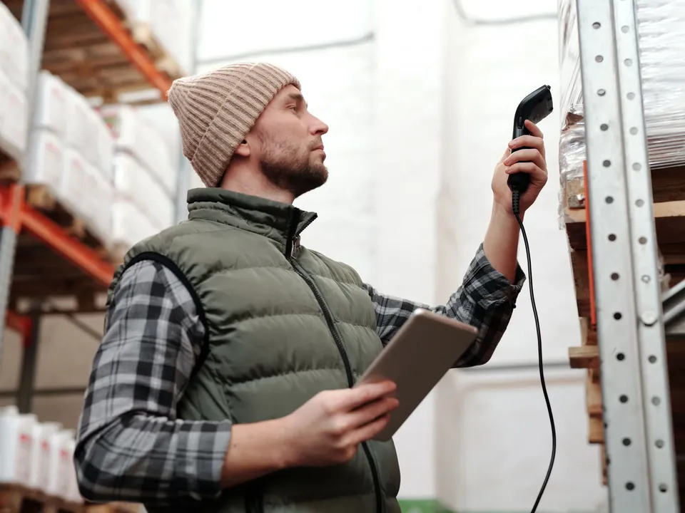 Warehouse employee using a tablet and handheld scanner