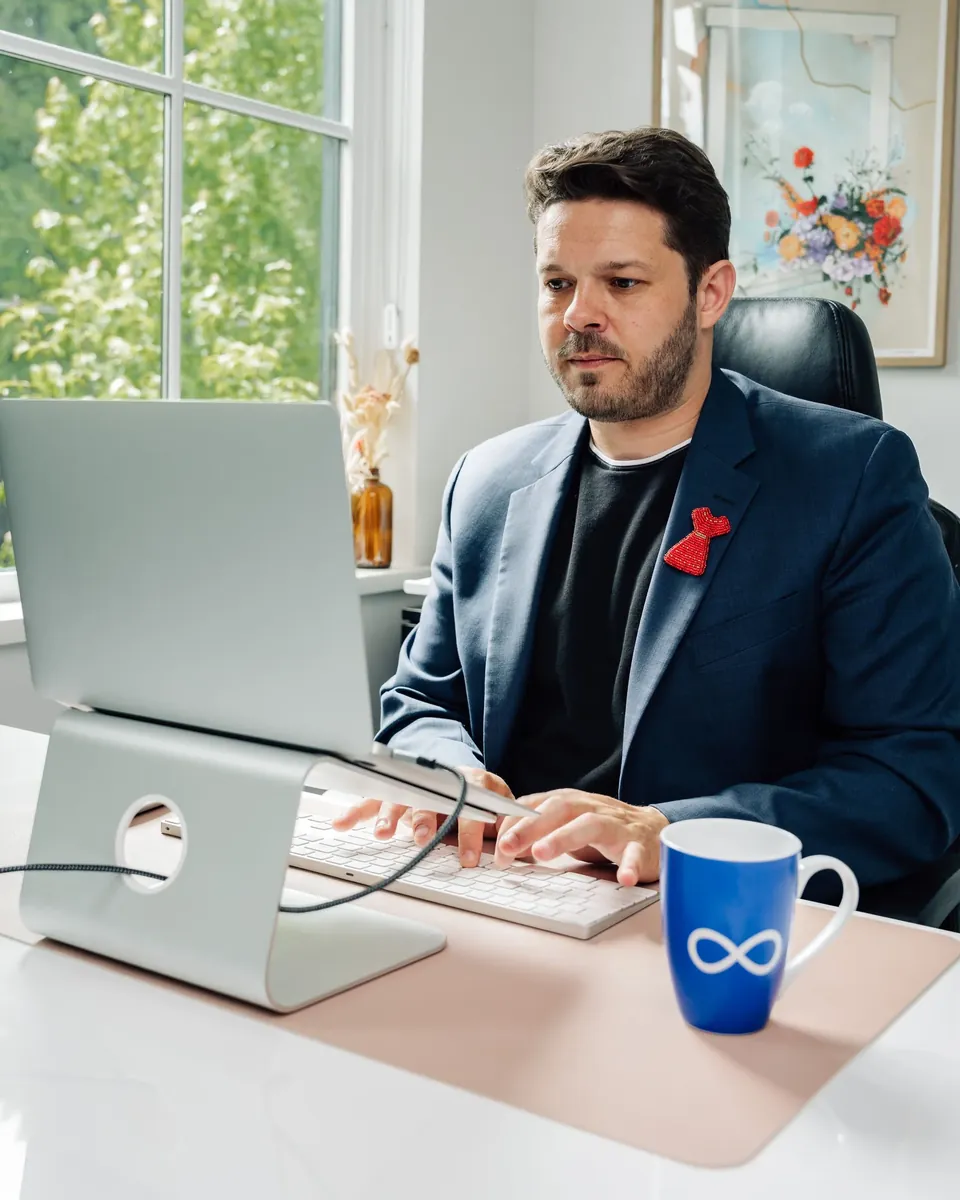 Professional working at a desktop computer in a bright office