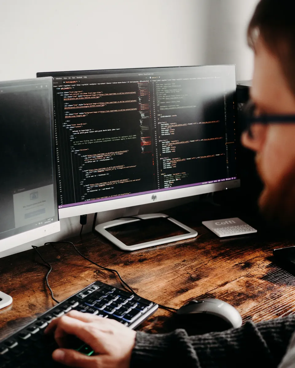 Developer working on software at a desktop computer