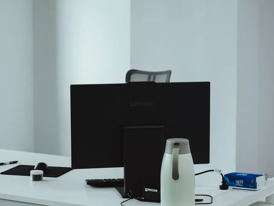 Computer monitor and accessories on a clean office desk